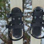 View of three strap ski binding mounted on skis