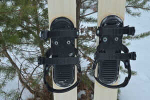 View of three strap ski binding mounted on skis
