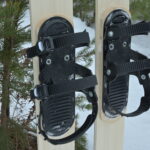 View of three strap ski binding mounted on skis