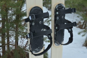 View of three strap ski binding mounted on skis
