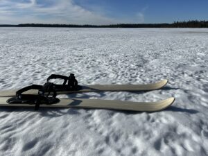 Pair of skis on frozen lake
