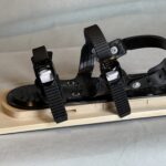 Top view of three strap ski binding mounted on a ski