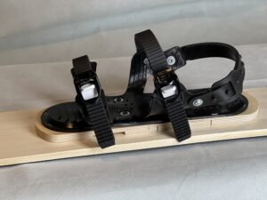 Top view of three strap ski binding mounted on a ski
